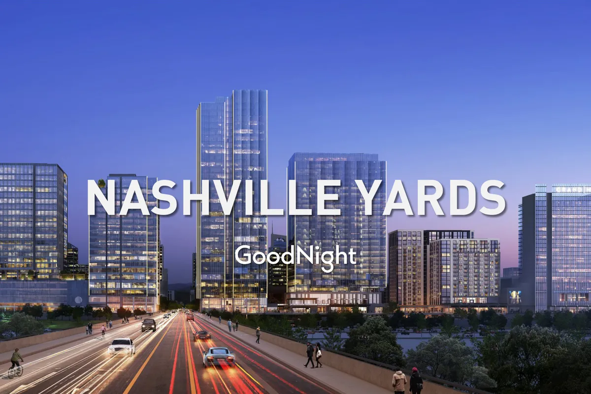 A vibrant nighttime view of skyscrapers illuminated by city lights, with a busy roadway in the foreground. The expansive skyline captures the energetic atmosphere of downtown Nashville, emphasizing the city's urban allure.