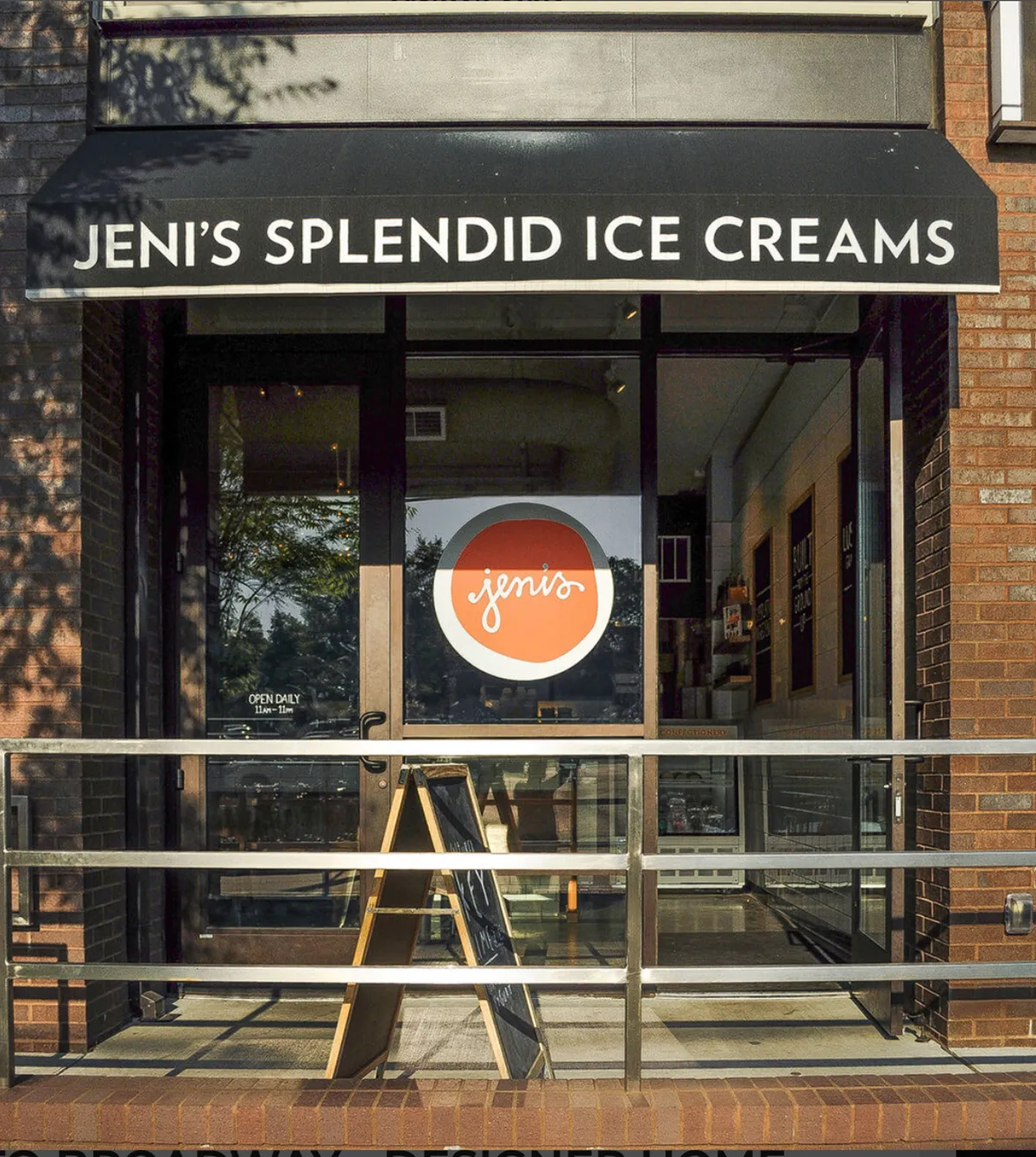 The cheerful storefront of Jeni's Splendid Ice Cream is displayed, with the signage and menu board visible. The open door and bright atmosphere invite families and friends to step in and enjoy a treat together, capturing the playful spirit of local dining.